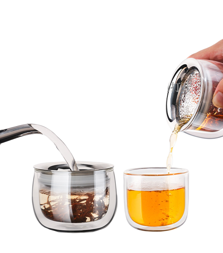 Double-wall glass infuser pot brewing loose-leaf tea beside a separate glass drinking cup