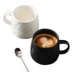 Black and white stone-texture ceramic mugs with coffee and stainless steel teaspoon