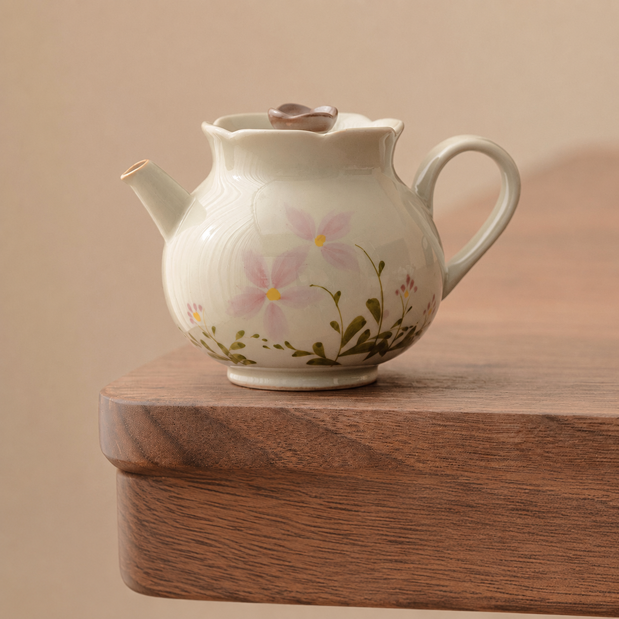Ivory ceramic teapot with pink floral pattern, lid, handle and pouring spout