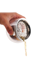 Tea pouring through the fine peony-pattern stainless steel filter of the glass infuser pot