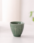 Green glazed ceramic tea cup with raised relief pattern from the BRUNMIIA portable tea set