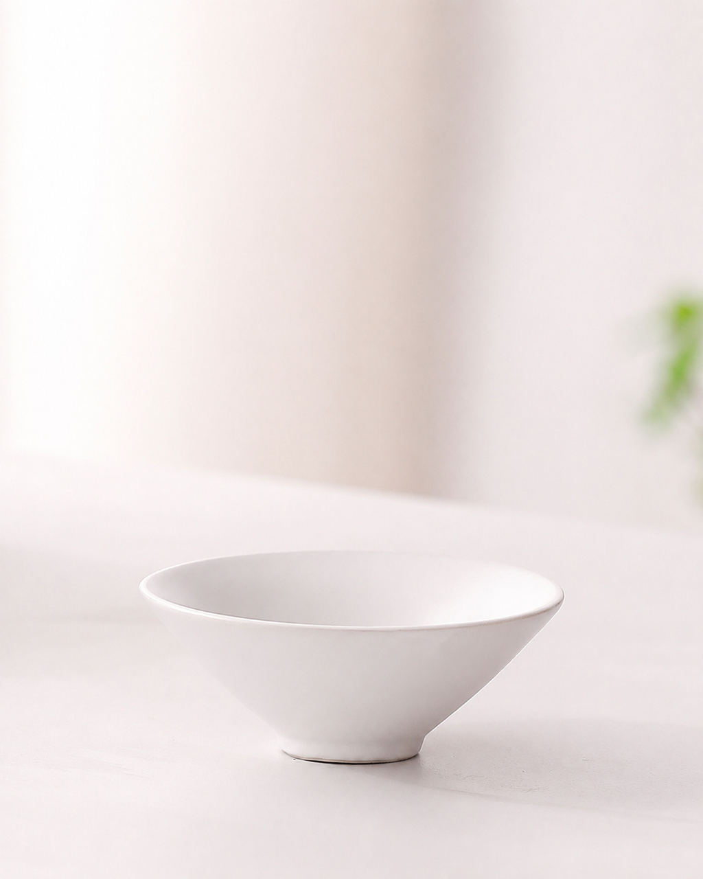 White shallow ceramic tea cup from the BRUNMIIA portable tea set