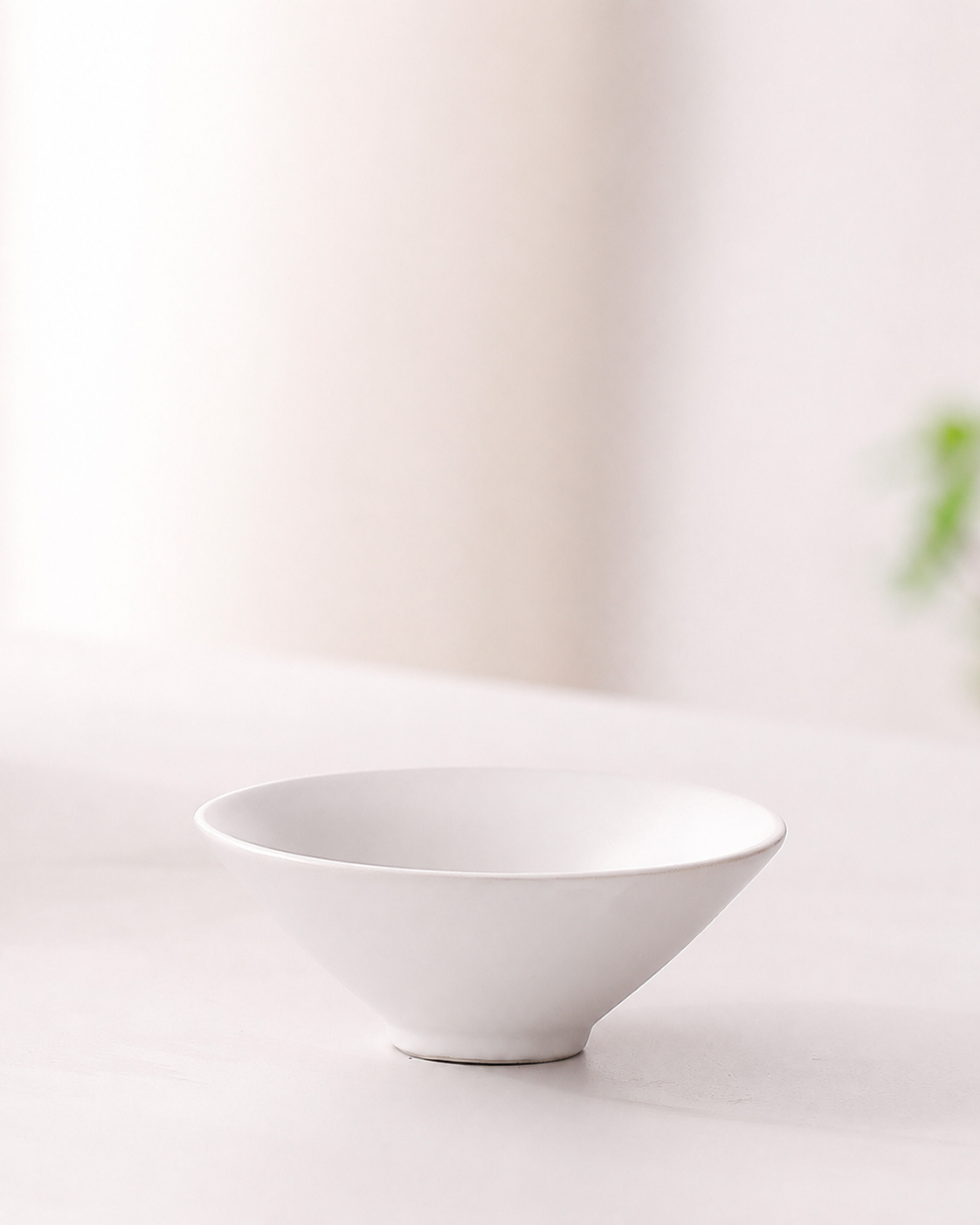 White shallow ceramic tea cup from the BRUNMIIA portable tea set