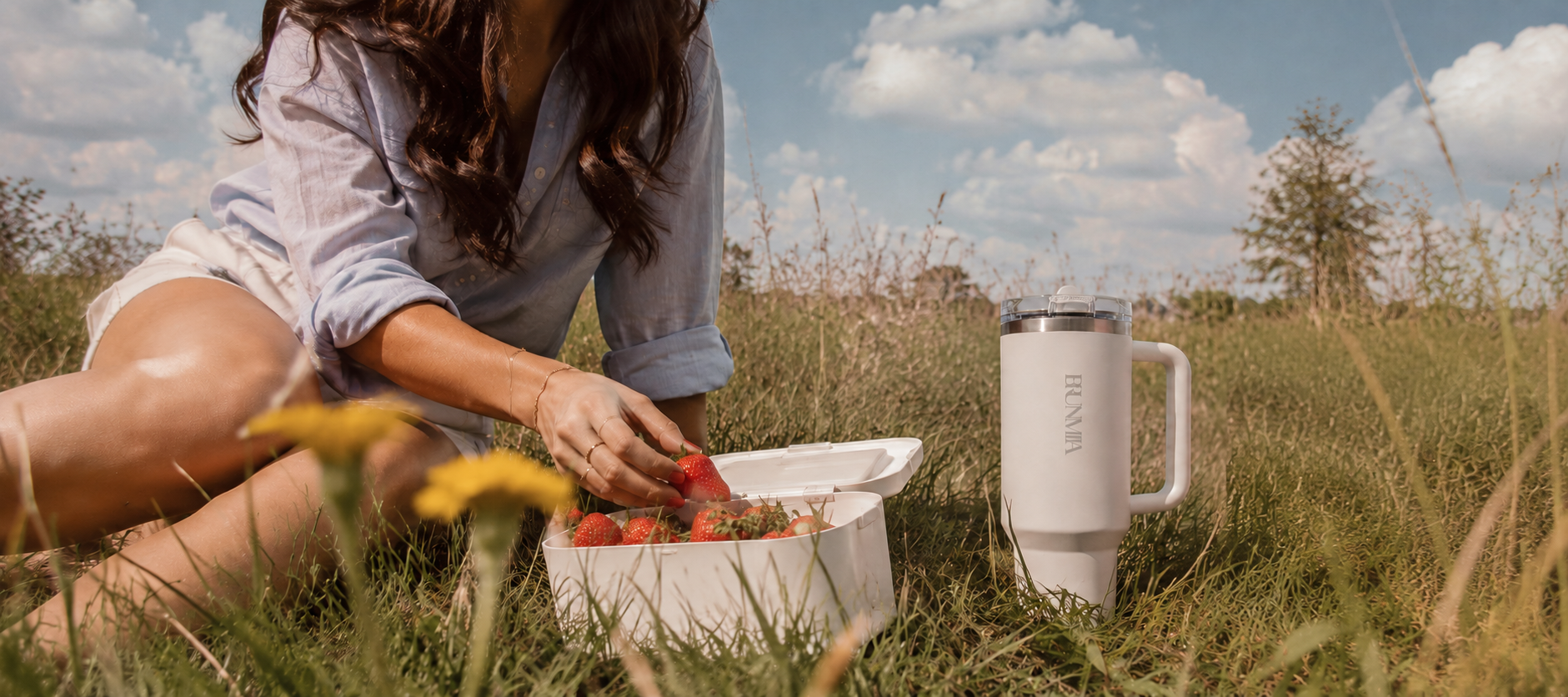 White BRUNMIIA handled tumbler beside strawberries during an outdoor picnic
