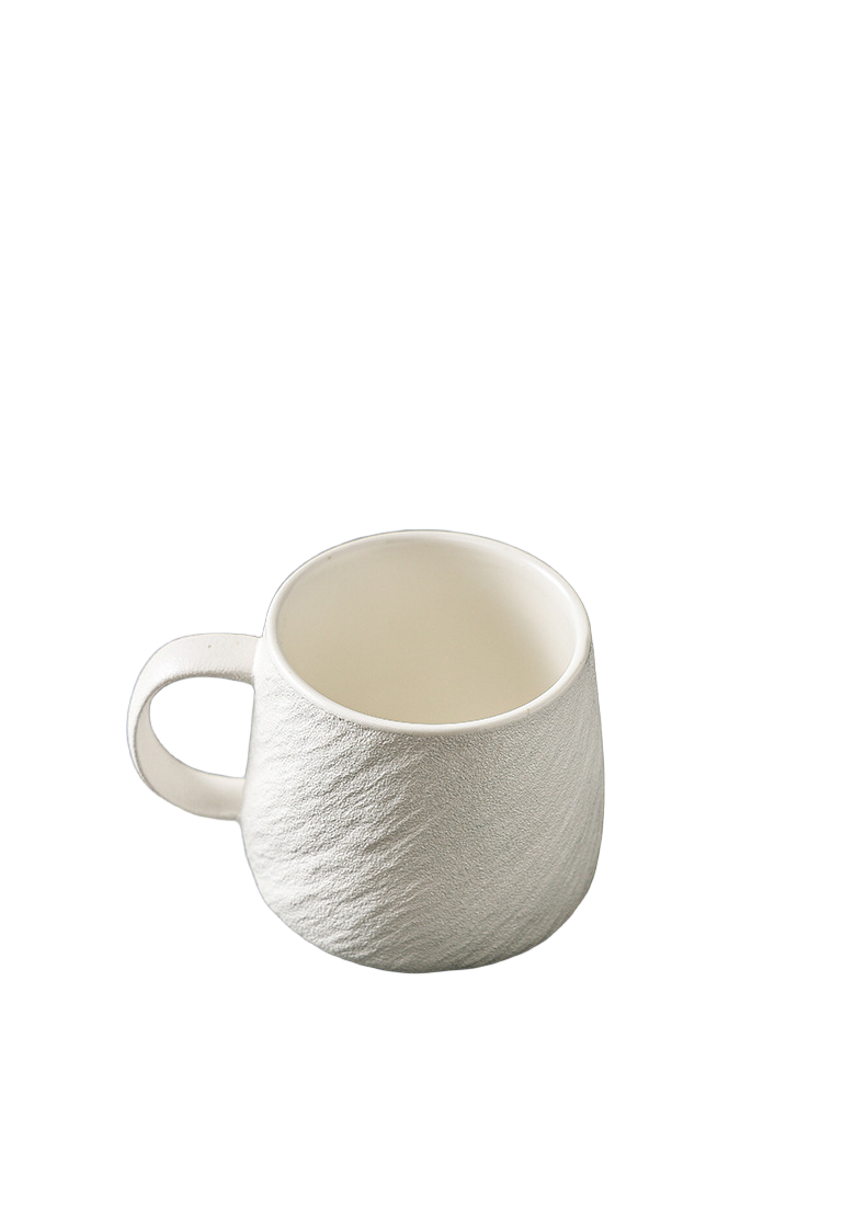 White ceramic mug with tactile stone-inspired texture, smooth rim and loop handle